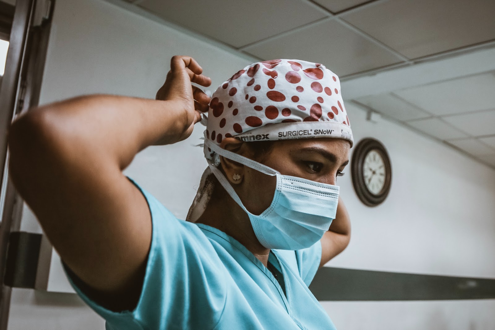 nurse putting on protective face mask